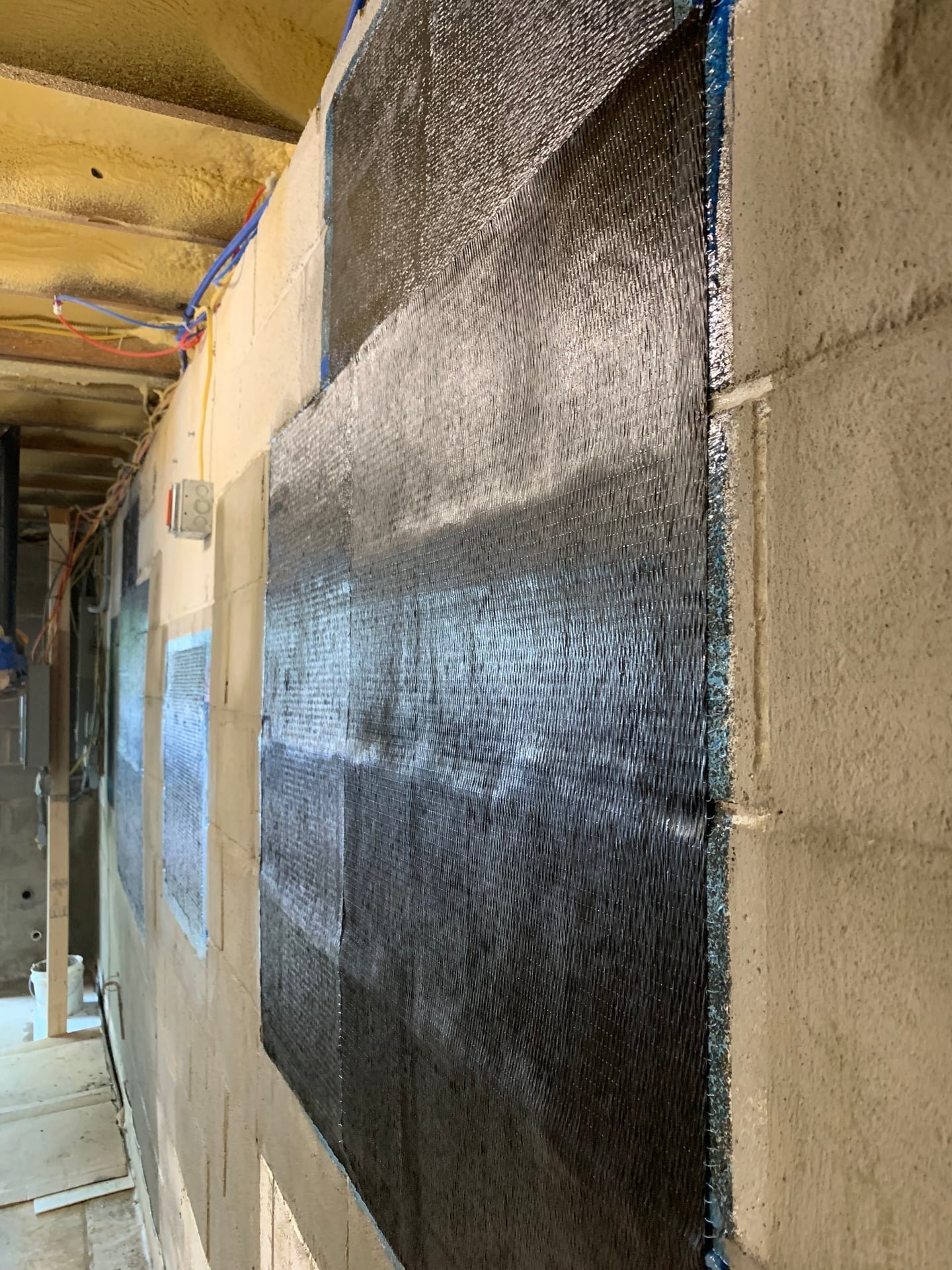 After: leaking basement wall crack repair with carbon fiber straps and waterproofing membrane in Mount Kisco, NY