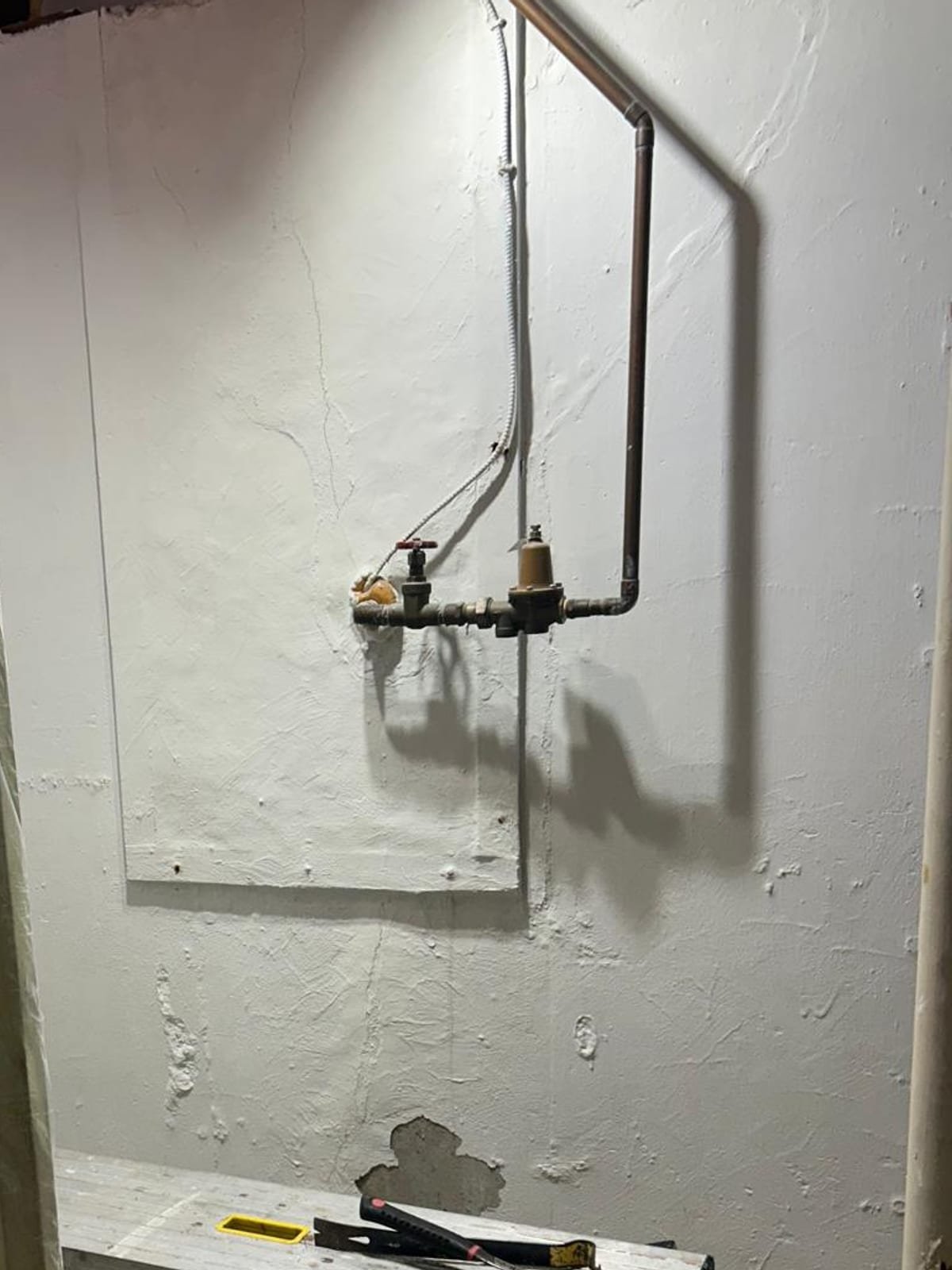 Before: full-wall carbon fiber reinforcement on a cracked basement foundation wall in Shelton, CT