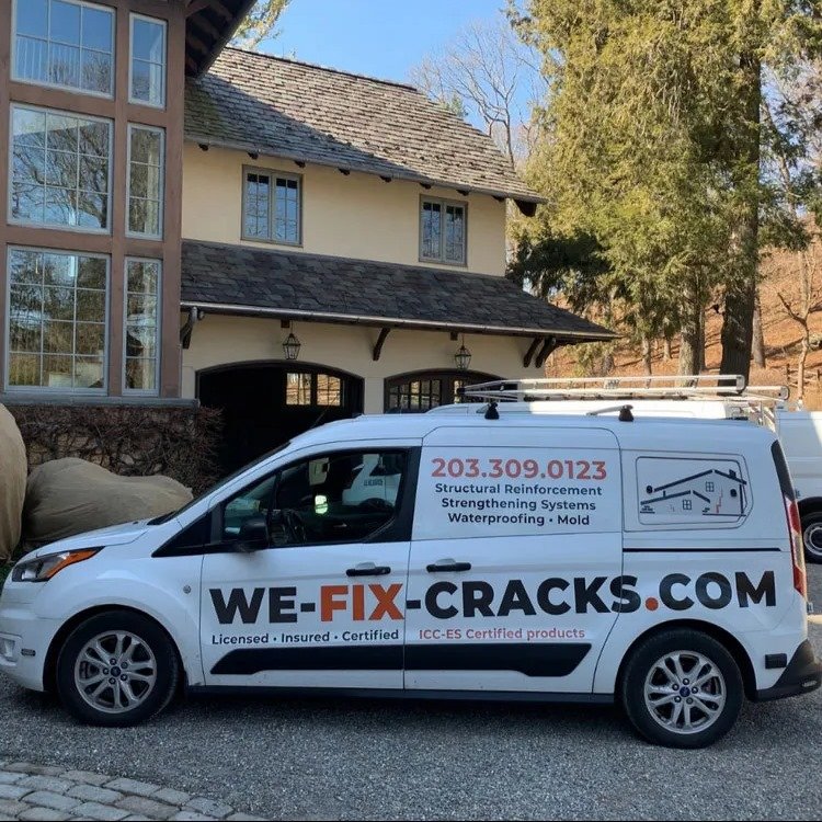 We Fix Cracks service truck parked outside a client's home