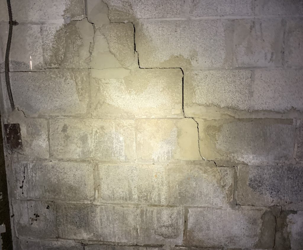 crack in brick wall going along edge of bricks